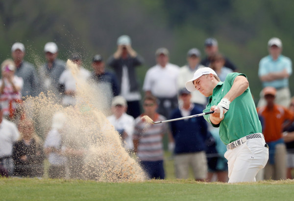 Jordan Spieth takes a shot from the bunker at the WGC-Dell Match Play