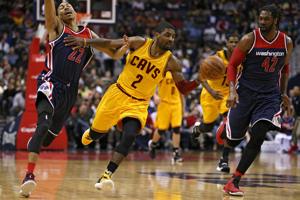 Kyrie Irving drives past Otto Porter Jr. and Nene Hilario of the Washington Wizards
