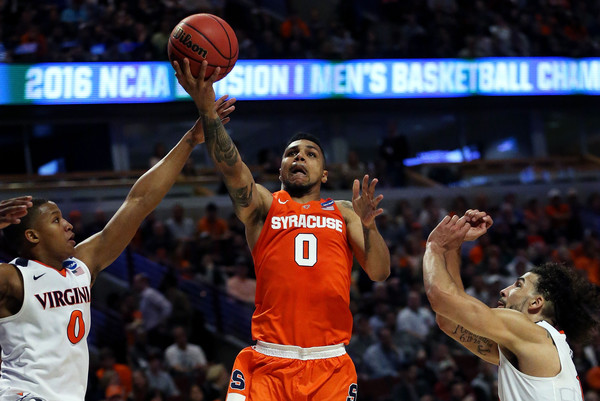 Michael Gbinije goes for the layup against Devon Hall of the Virginia Cavaliers