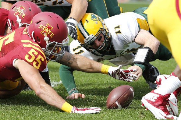 Carson Wentz attempts to recover a fumble in a game against Iowa State