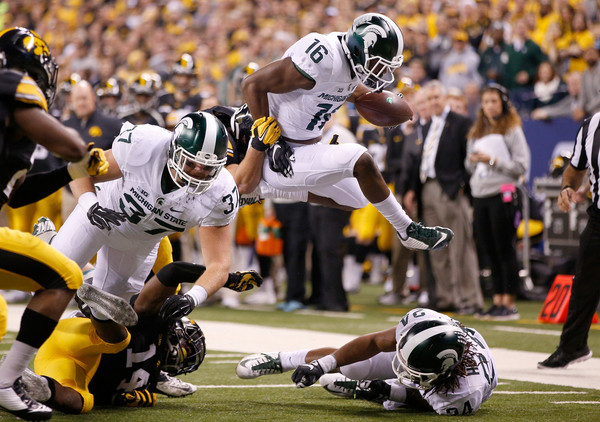 Aaron Burbridge leaps over opponents and teammates in a game against Iowa