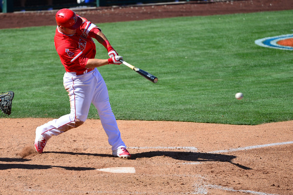 Mike Trout hits a single during a spring training game against Texas