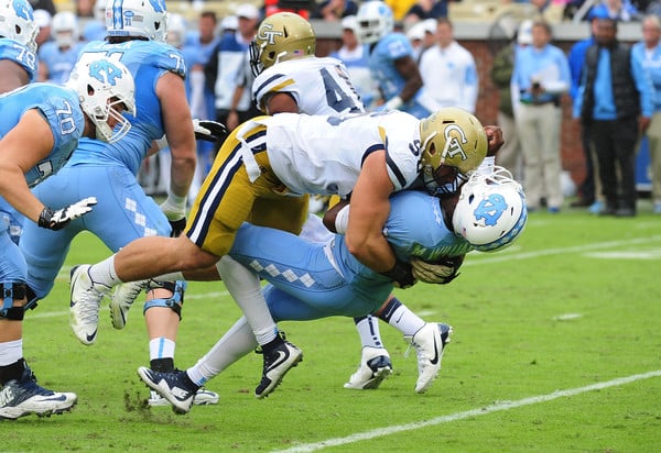 Adam Gotsis delivers a hard hit on Marquise Williams of the North Carolina Tar Heels