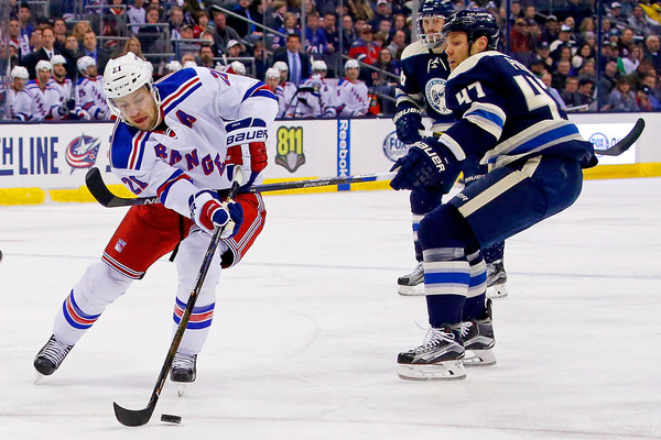 Derek Stepan attempts to break free from Dalton Prout