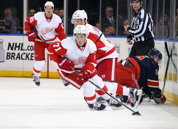 Dylan Larkin skates with the puck