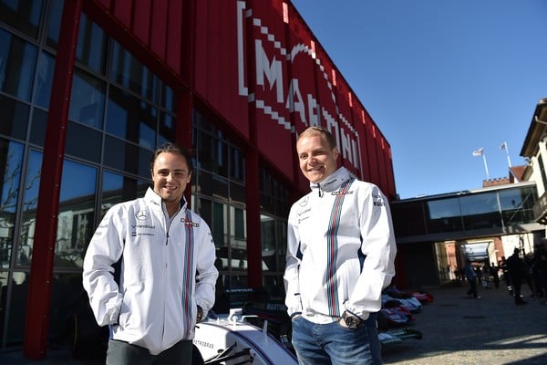 Felipe Massa and Valerie Bottas pose in front of the Williams car