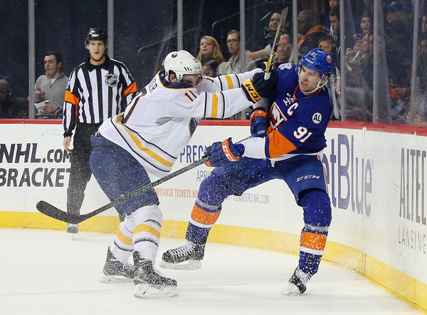 John Tavares gets checked against the Sabres