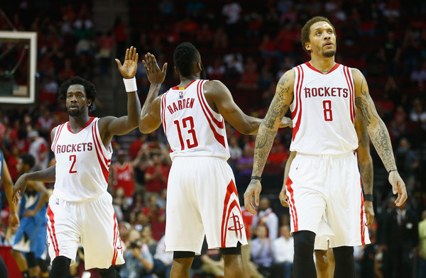 James Harden, Patrick Beverley and Michael Beasley celebrate on the court against the Minnesota Timberwolves
