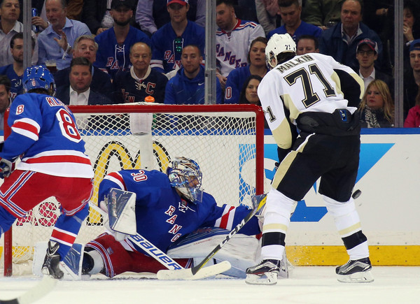 Henrik Lundqvist saves a shot from Evgeni Malkin