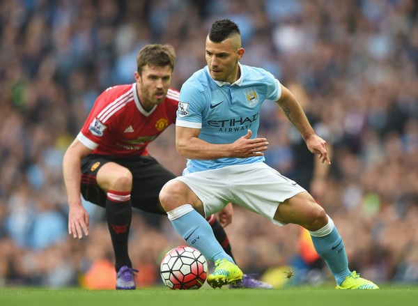 Sergio Aguero locked in a battle with Michael Carrick