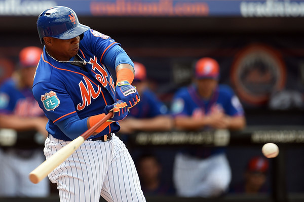 Yoenis Cespedes swings at a fastball pitch