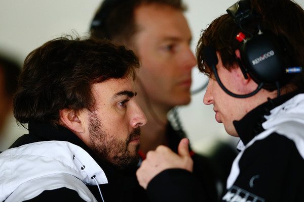 Fernando Alonso talks with a McLaren mechanic