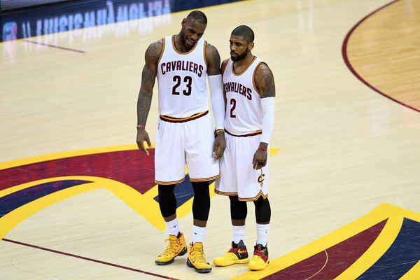 LeBron James and Kyrie Irving having a conversation at midcourt