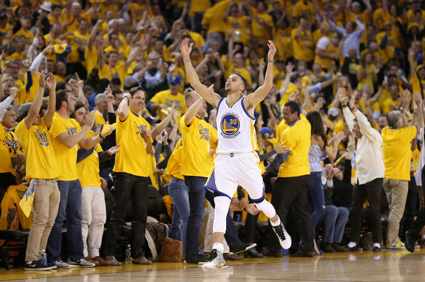 Stephen Curry celebrates after hitting a three