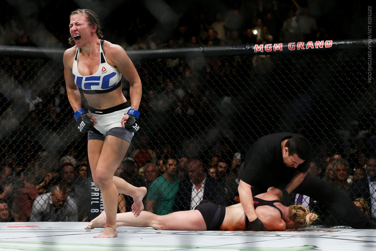 Miesha Tate celebrates after choking out Holly Holm