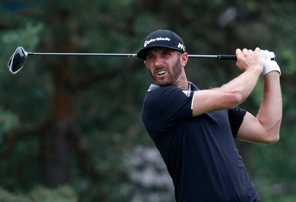 Dustin Johnson watches his drive