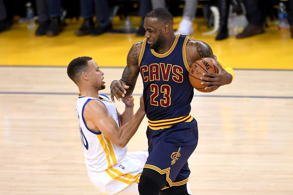 LeBron James charges through Stephen Curry