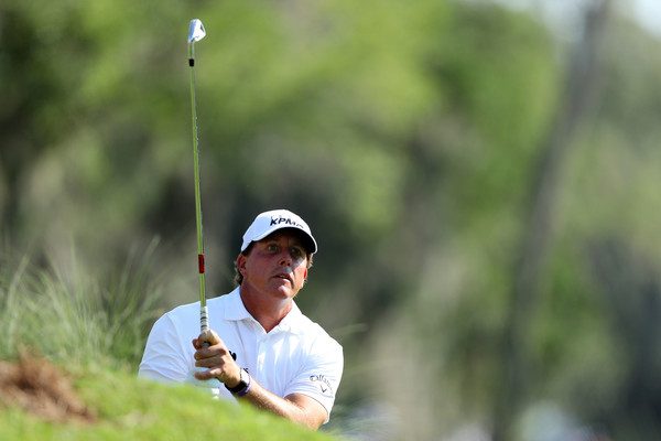 Phil Mickelson hits an iron shot