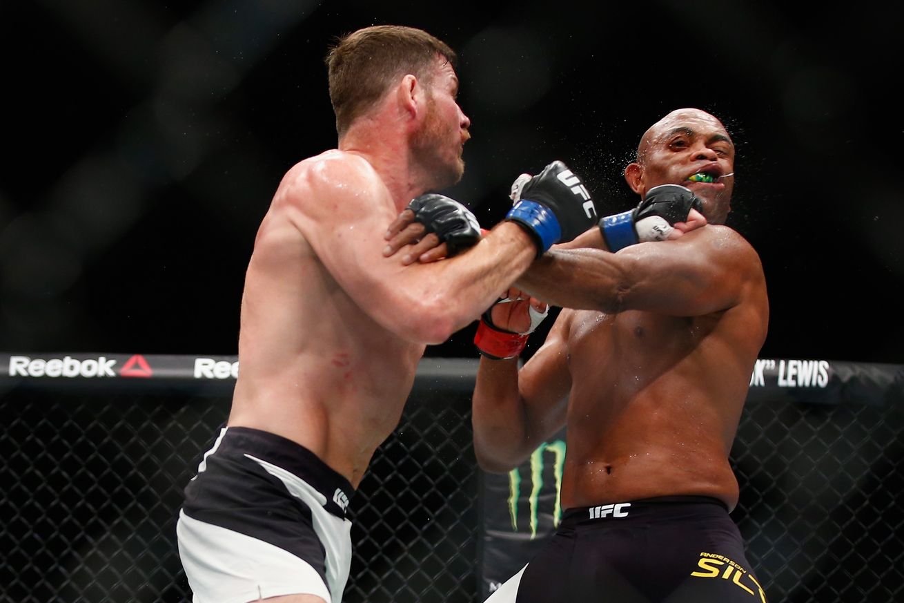 Michael Bisping lands a left hook on Anderson Silva