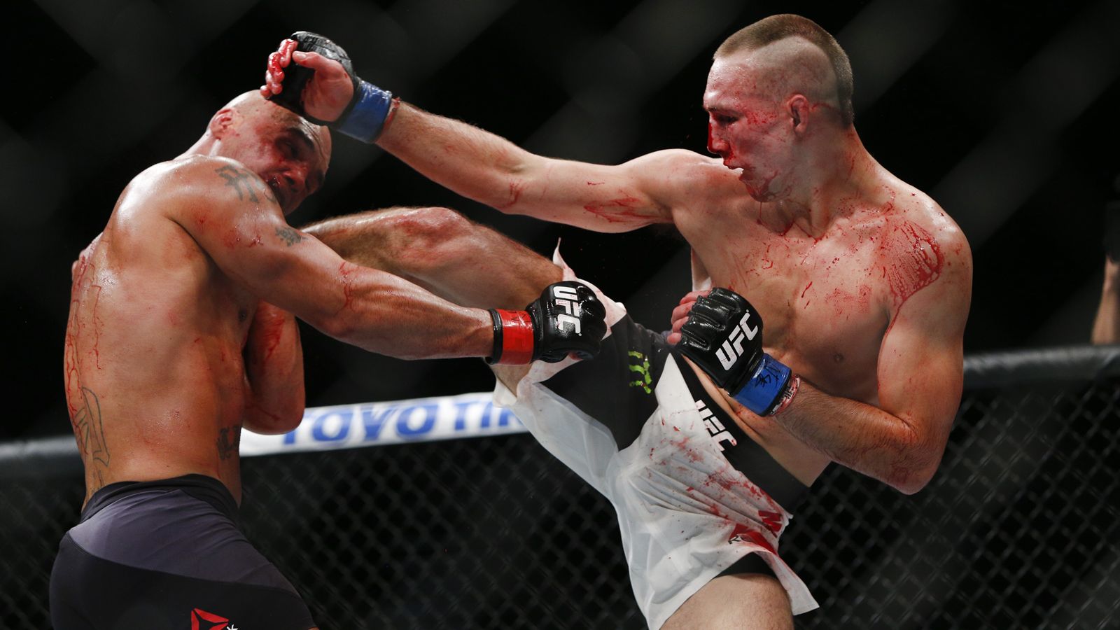 Rory MacDonald lands a head kick on Robbie Lawler