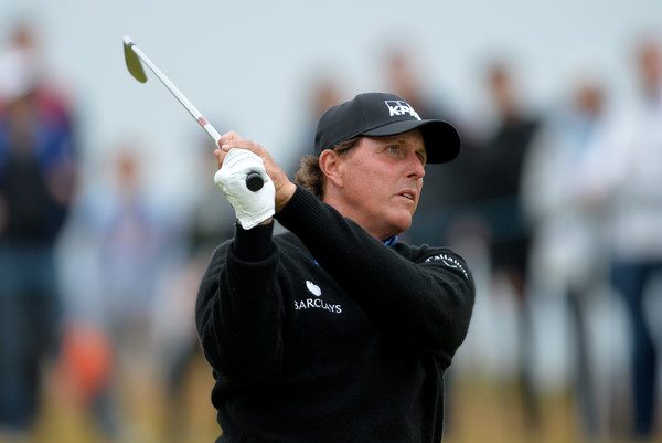 Phil Mickelson watches his iron shot